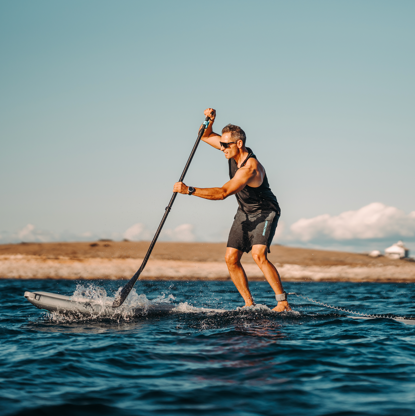 Man riding SipaBoards electric SUP in water.