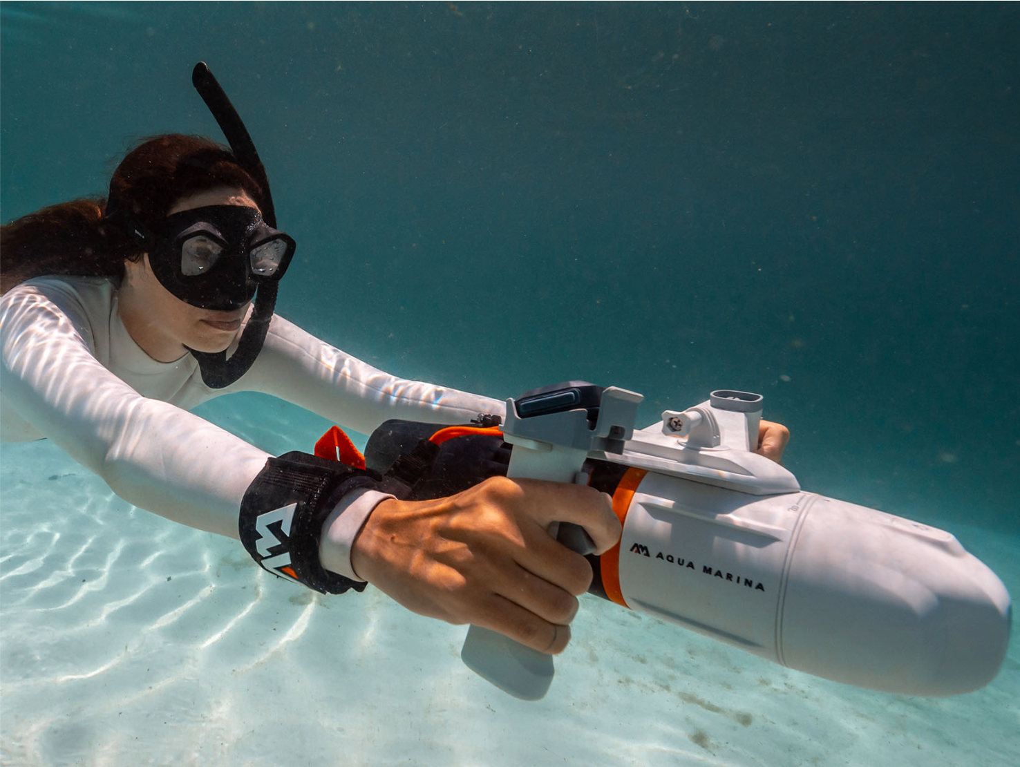 Girl propelling underwater with Aqua Marina BlueDrive X Water Propulsion Device.