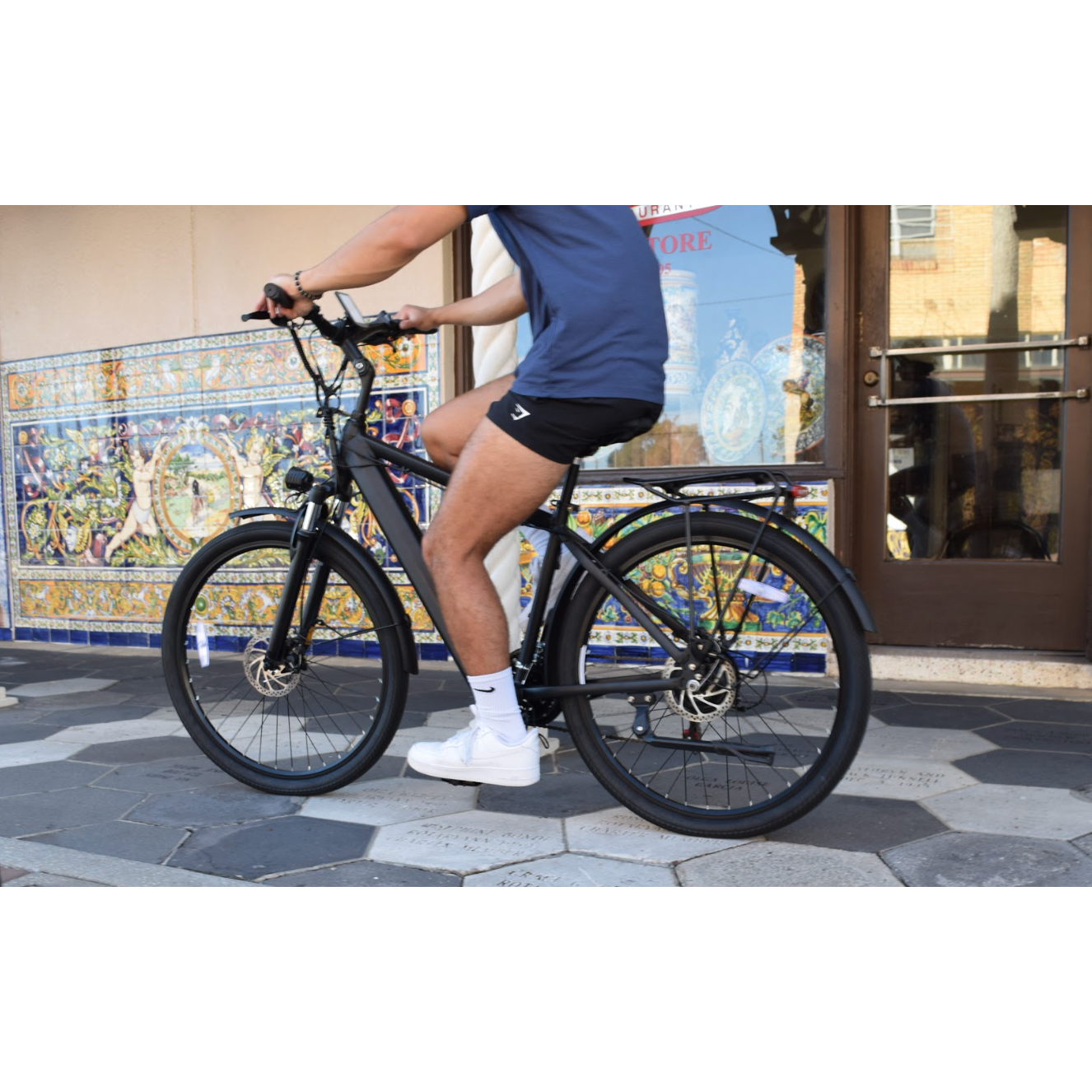 Guy riding in city on Jupiter Tempo Electric Bike.