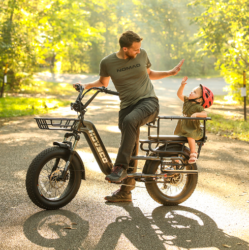Man high-fiving daughter on the back of his HOVSCO HovCart Cargo E-Bike with trees in the background.