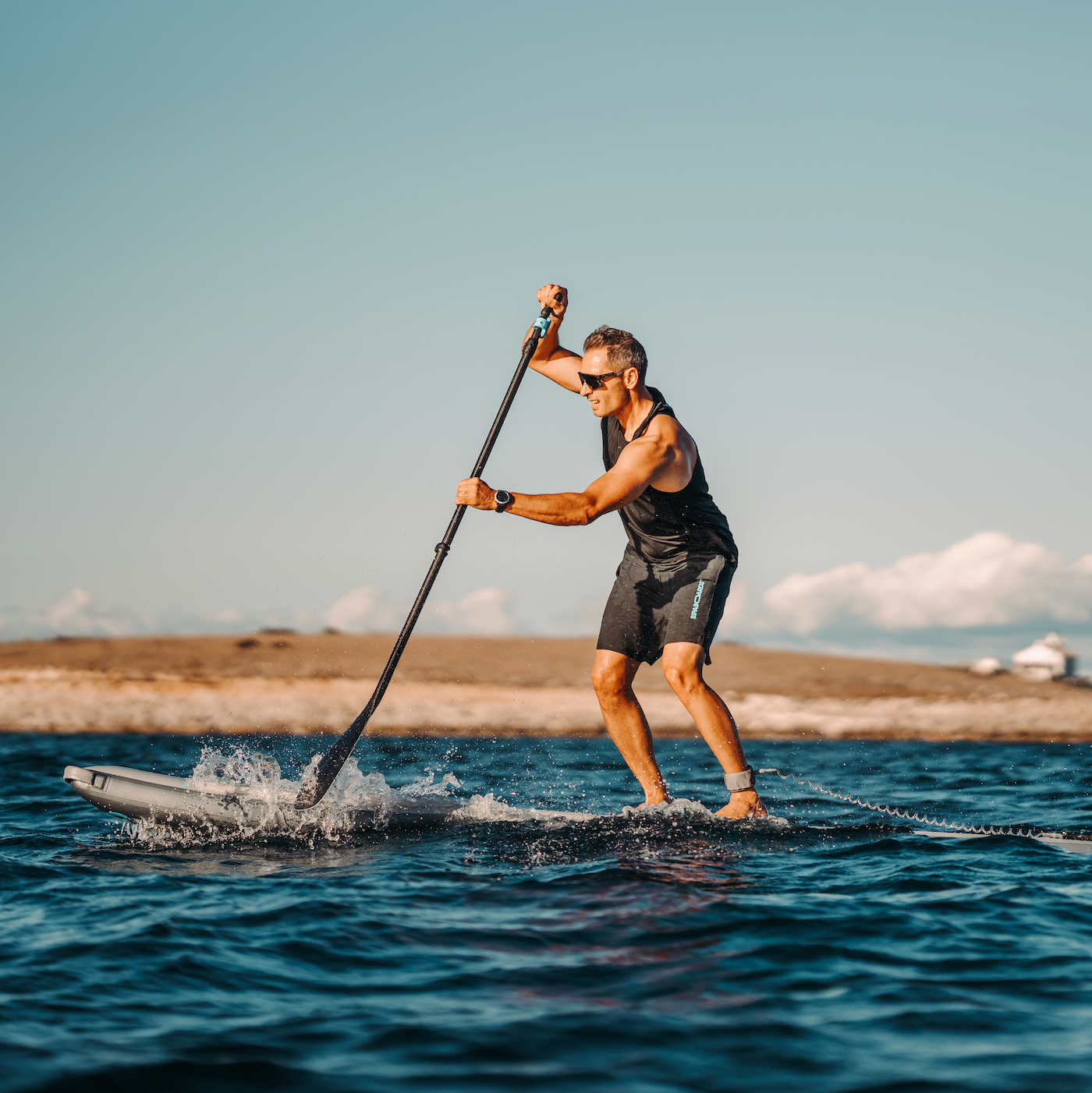 Man riding SipaBoards electric SUP in water. 