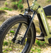 A close up shot of the Olive Green Mokwheel Basalt 2.0 ST eBike fat tire electric bikes front suspension.