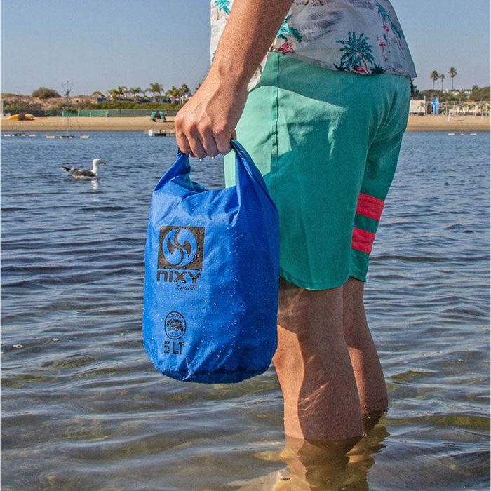 NIXY Dry Sack Man Holding 5 LIter While Standing In Water