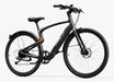 A dark gray step-over electric bike with orange accent lines and a black seat, manufactured by Urtopia and called the Carbon Classic and shown from a side profile on a white background.