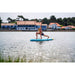 Girl on Aqua Marina Dhyana Inflatable SUP looking away doing yoga pose. 