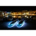 Aqua Marina Glow SUPs with Ambient Light System on at night in marina town. 