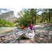 Couple unrolling their Halve Inflatable Kayak on riverbed. 