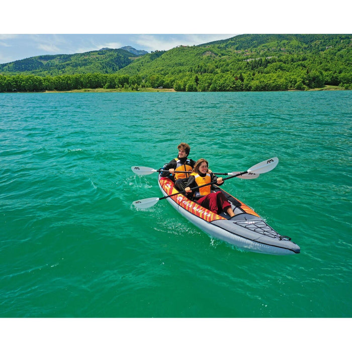 Couple paddlers in Aqua Marina Memba 2-seat inflatable kayak on lake.