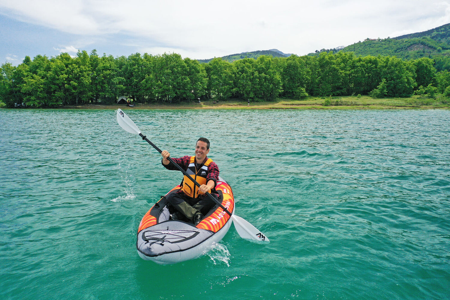 Guy paddling Aqua Marina Memba 330 Inflatable Kayak on lake.