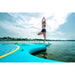 Aqua Marina Fitness Series Yoga Dock and Dhyana SUP attached with girl standing on one leg. 