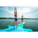 Aqua Marina Yoga Dock with sup attached, girls standing. 