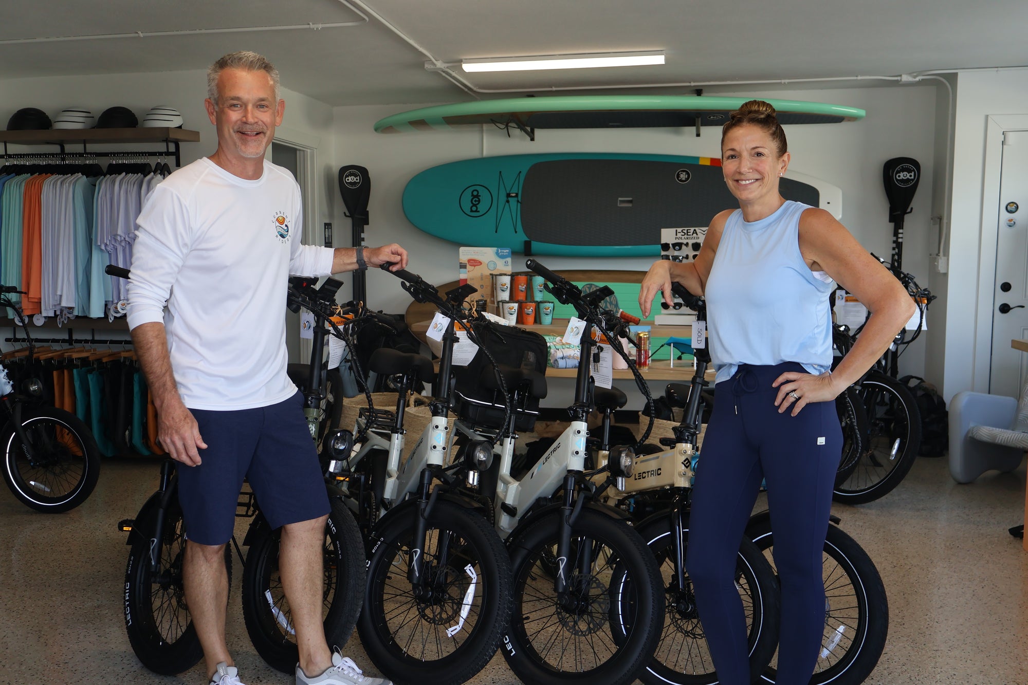 Brian and Michelle standing in their store Current Riders in Fort Myers Beach, Florida.