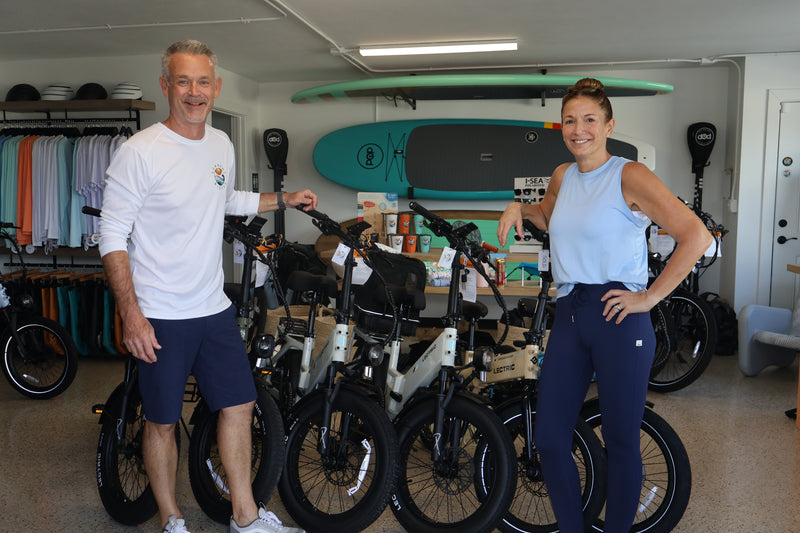 Brian and Michelle standing in their store Current Riders in Fort Myers Beach, Florida.