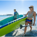 Couple carrying iSUPs into the water with hers being a Jimmy Styks Neptune iSUP.