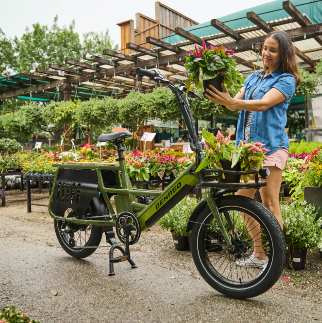 Girl at plant nursery with Denago Compact Cargo 1 Electric Bike.