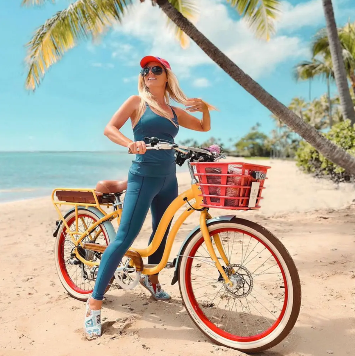 Girl on Electric Bike Company Model S on the sand of a beach.