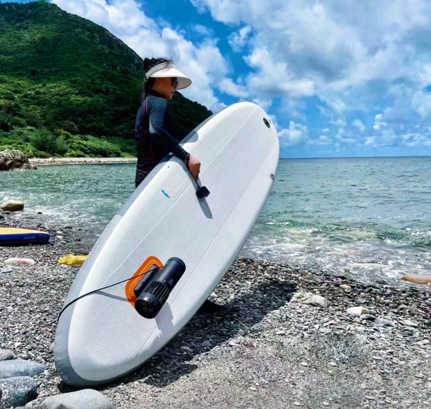 Girl holding SUP with LEFEET S1 Pro attached. 