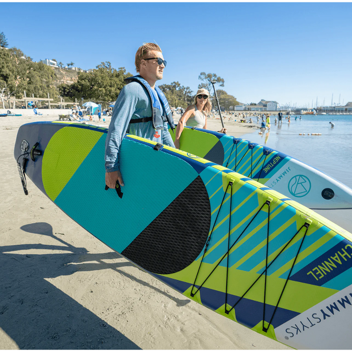 Guy carrying his Jimmy Styks Channel iSUP to the water with a girl carrying her own board.