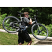 Guy carrying on his shoulder the matte black Urtopia Carbon 1 Pro E-Bike.