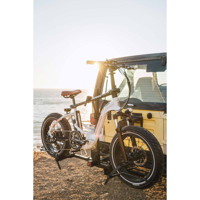 Bicycle attached to a Hollywood Racks Sport Rider bike rack on a beach near the ocean.