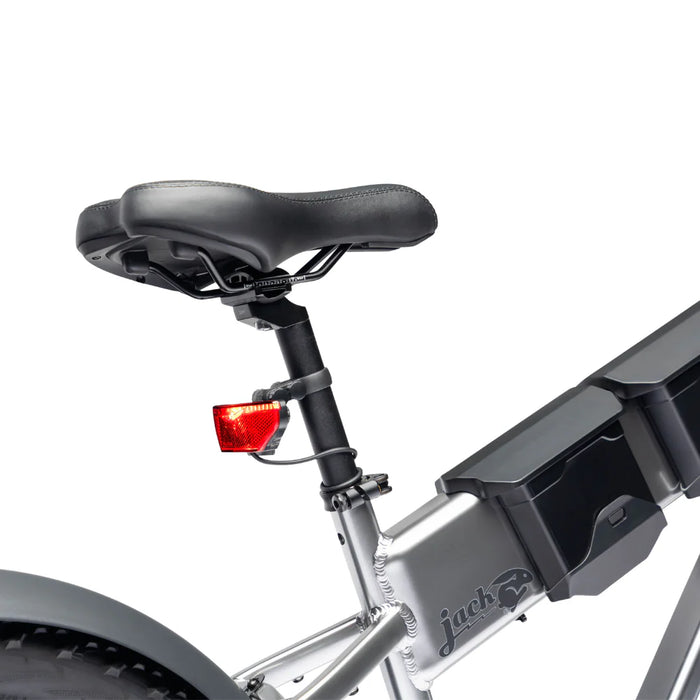Close-up of a JackRabbit Renegade electric bike seat and rear light on a white background.