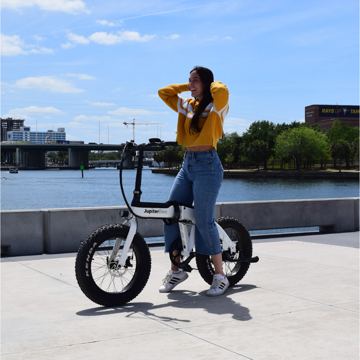 Girl on Jupiter Defiant ebike on bridge. 