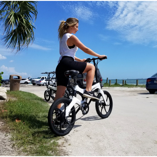 Girl on Jupiter Discovery X7 E-Bike at a beach.