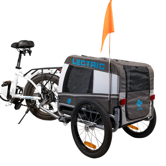 Lectric Pet Trailer behind a bicycle on a white background.
