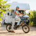 Guy on Lectric XP Step-Thru 3.0 Black Long-Range eBike in front of RV.