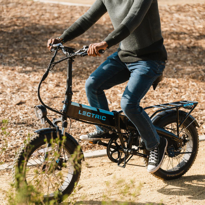 Guy on Lectric XP Step-Thru 3.0 Black Long-Range eBike in a park.