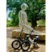 Two Lectric XP4 electric bikes parked in front of a wire sculpture of a person sitting outdoors