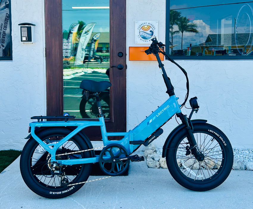 Lectric XP4 electric bike parked outside Current Riders in Fort Myers Beach, Florida.