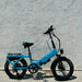 Lectric XP4 Raindrop Blue step-over electric bike parked near a wall outside.
