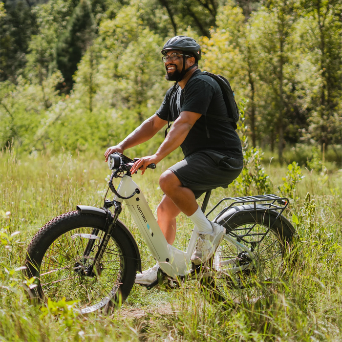 Guy riding on a Lectric XPeak Step-Thru 2.0 eBike in the woods. 