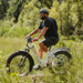 Guy riding on a Lectric XPeak Step-Thru 2.0 eBike in the woods. 