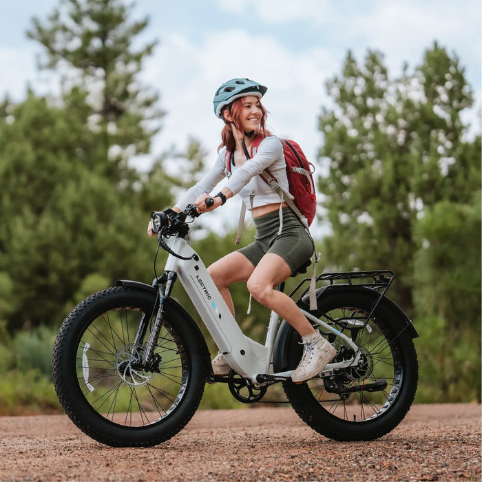 Girl on a Lectric XPeak Step-Thru 2.0 Electric Bike outside.