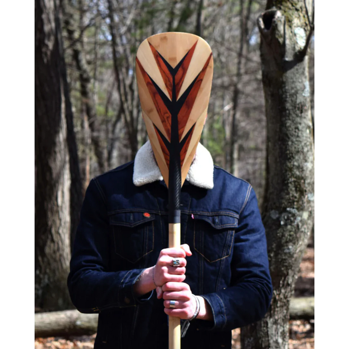 Loon Paddle Company Carbon & Bamboo Feather Paddle Person Standing Holding Paddle In Front Of Face