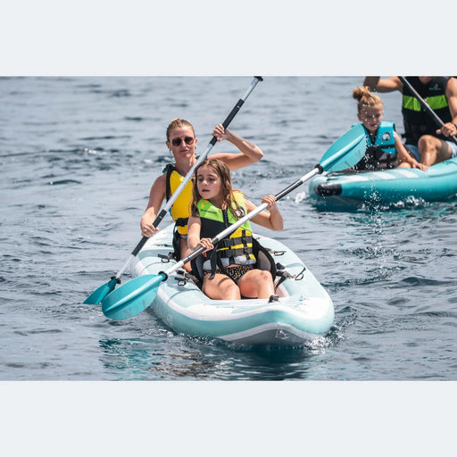 Mother and daughter in one Spinera Adriatic Kayak with father and daughter in second one behind them out on the water.