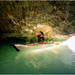 Guy riding in his Oru Kayak Bay ST Foldable Kayak in a cave.