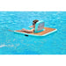 Person sitting in ParadisePad Inflatable Chair in a pool