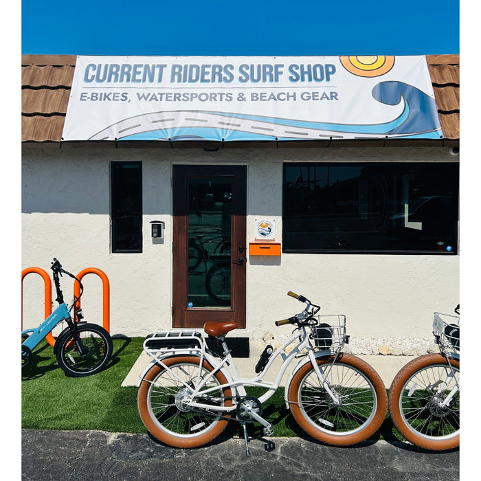 Priority Bicycles E-Coast white step-thru ebike in front of Current Riders Fort Myers Beach. 