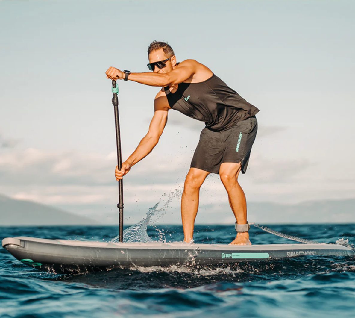 Guy powering SipaBoards electric SUP through waves.