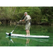 Older man paddling down a stream on a SipaBoards Drive Fisherman with fishing gear.