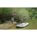 Older man with his SipaBoards Drive Fisherman Electric iSUP on the shore of a stream getting ready to go fly fishing.