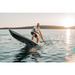 Man riding a SipaBoards Drive Tourer Silver Electric SUP with the front end out of the water.