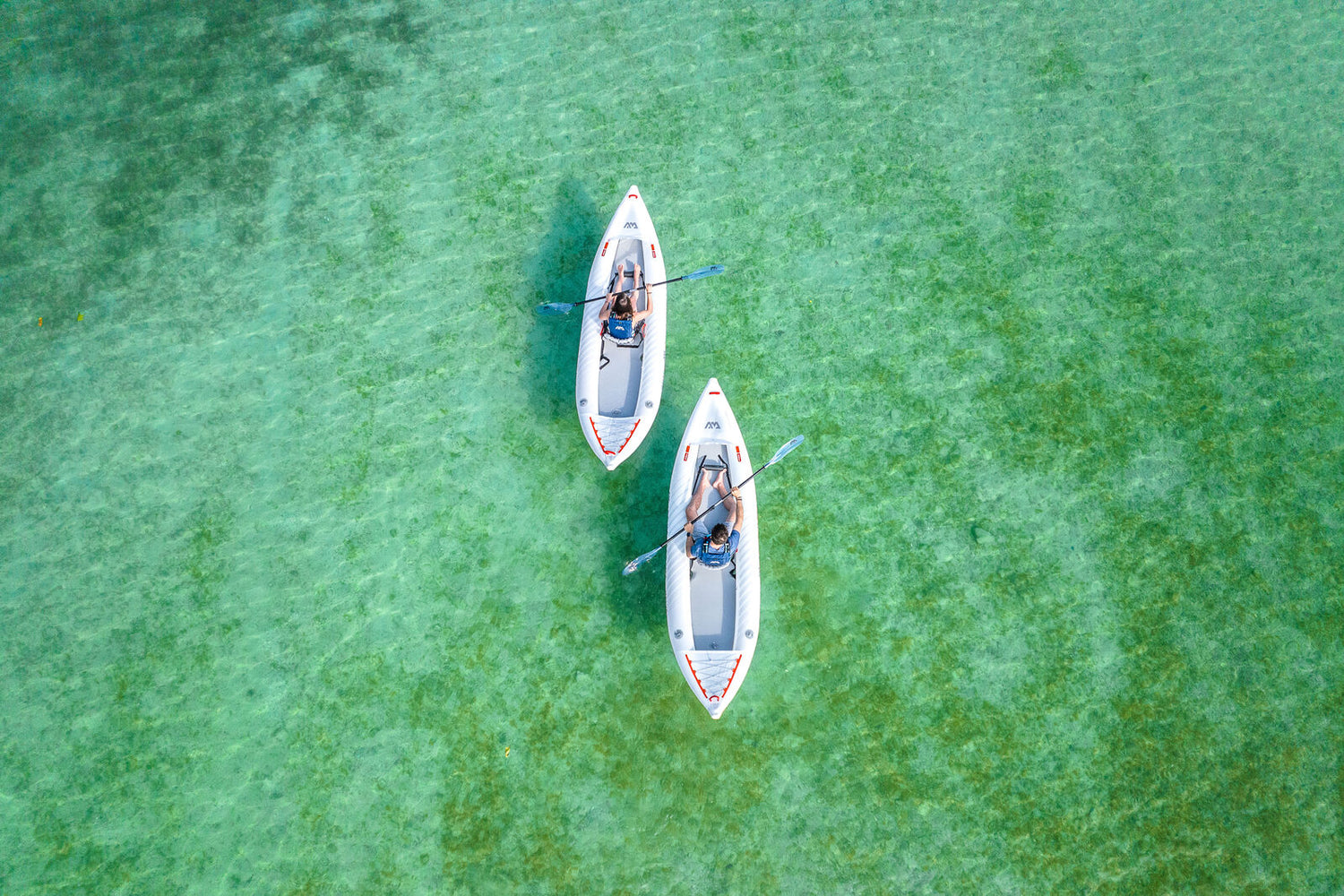 Overhead view of two Aqua Marina Halve Kayaks in clear tropical water. 