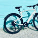 Urtopia Carbon 1 Pro eBike back tire against a light blue wall.