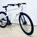 Urtopia Carbon 1 Pro eBike front end on a light gray floor against a white wall.