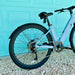 Urtopia Carbon ST back ebike tire in front of aqua colored door. 