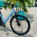 Urtopia Carbon ST ebike's front tire parked outside Fort Myers Beach rental house First Mango.